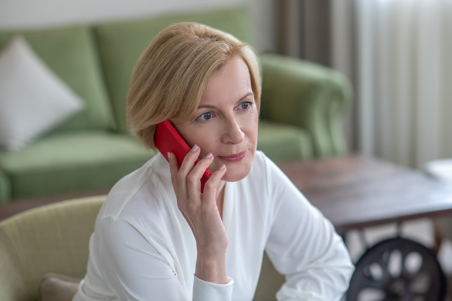 A woman listening closely on the phone